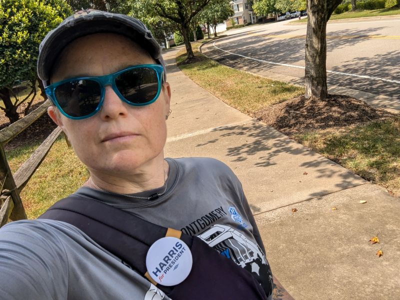 Selfie of Karen Taggart in sunglasses going door-to-door to get out the vote.